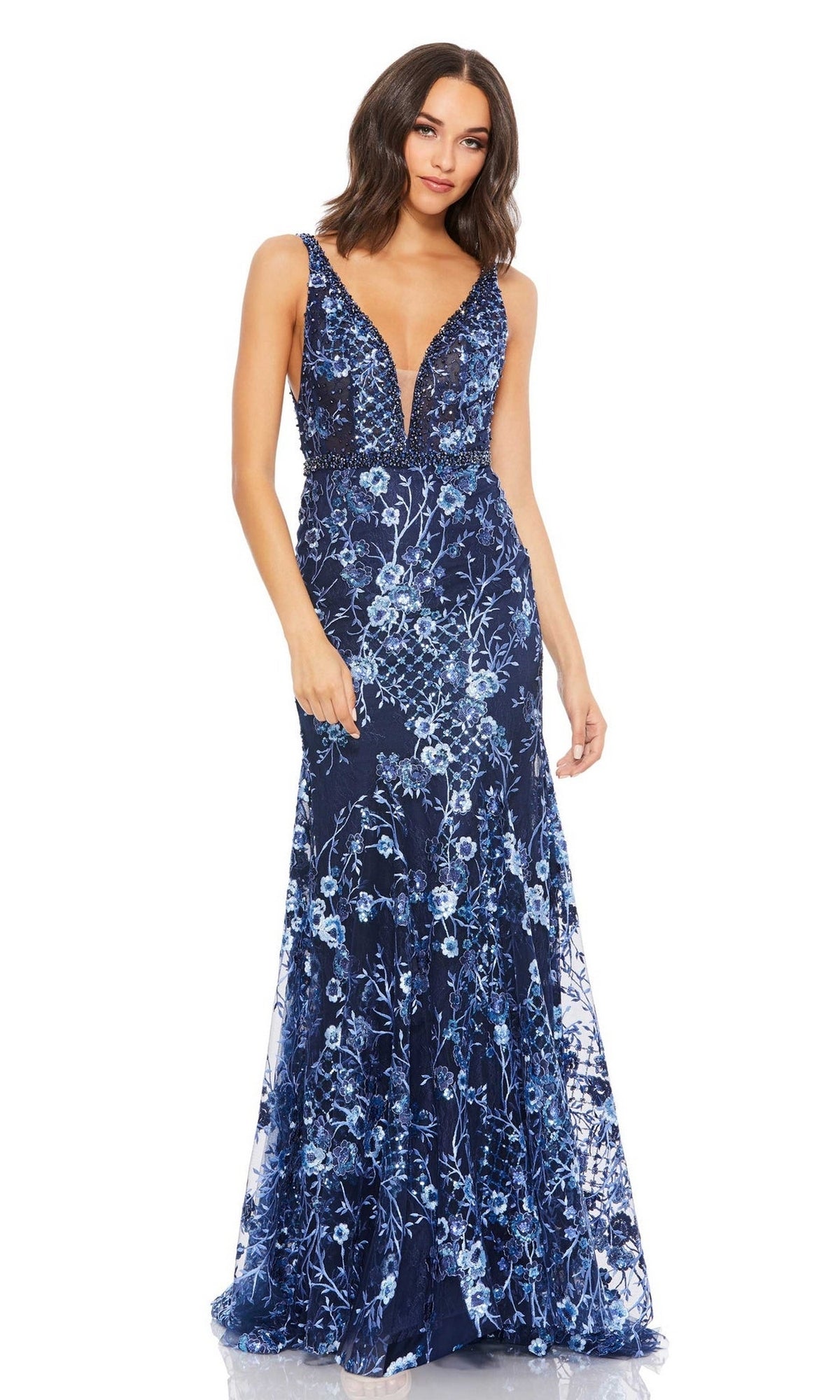 Woman wearing the Mac Duggal 67481 long floral-print formal dress, a sleeveless evening gown with a deep V-neck and intricate light blue embroidery on a floor-length navy silhouette.